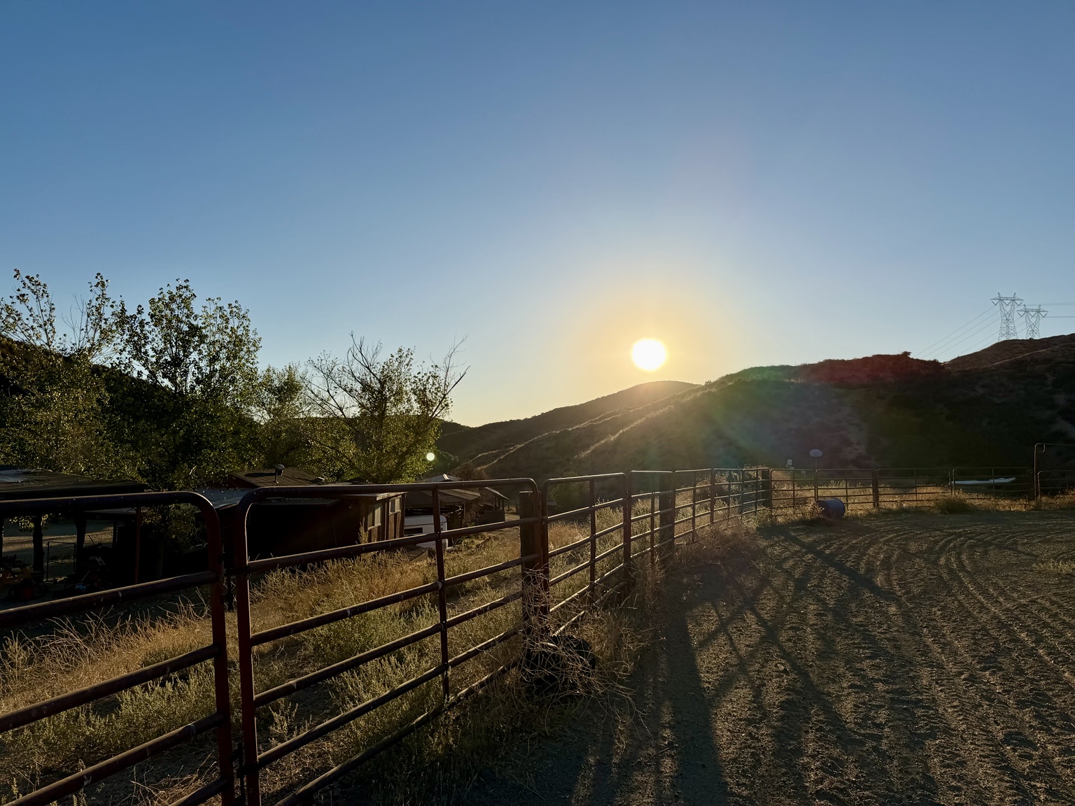 Sunset over the hills and fenced paddocks at our Angel Trust ranch